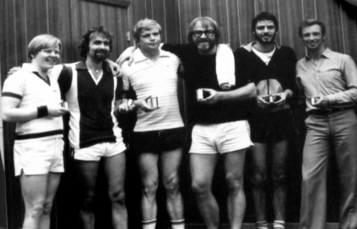 Number 4 from left you see Jens Theander. He has just won a badminton trophy. Peter Theander made a big hall for storing magazines, but the half of the hall was made for badminton so the employees could play some badminton.